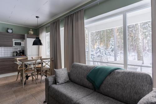 a living room with a couch and a table at Saimaa Life Apartments in Imatra