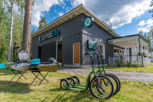 a bike parked in the grass in front of a building at Saimaa Life Apartments in Imatra