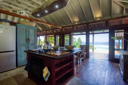 a kitchen with an island with a counter top at Aloha 6 in Ponta Mamoli