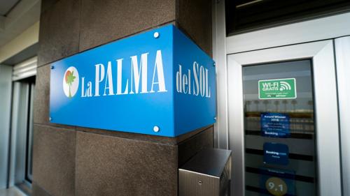 a blue sign on a wall in a store at La Palma Del Sol in Barletta