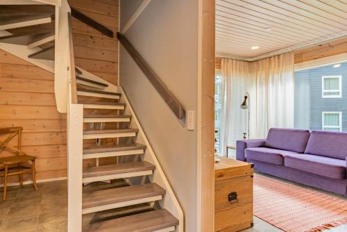 a staircase in a house with a purple couch at Saimaa Life Apartments in Imatra