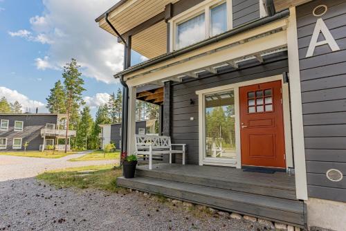 a house with a red door and a porch at Saimaa Life Apartments in Imatra