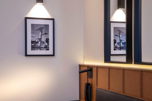a room with three pictures hanging on the wall at Hôtel du Port in Nogent-sur-Marne