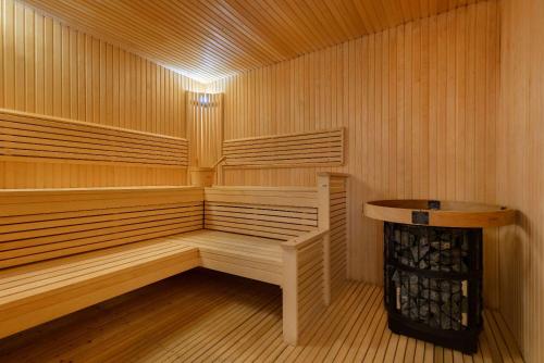 a sauna with a bench in the middle of it at Wyndham Garden Muscat Al Khuwair in Muscat