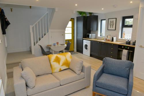 a living room with a couch and a chair at Nest House Super cosy one bedroom detached lodge center Huntingdon in Huntingdon