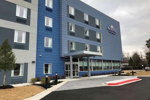 a blue building with a sign on the front of it at Microtel Inn & Suites by Wyndham Hot Springs in Hot Springs