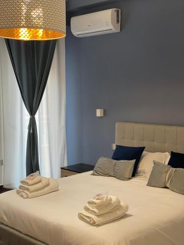 a bedroom with a bed with two towels on it at Relais Petruzzelli in Bari