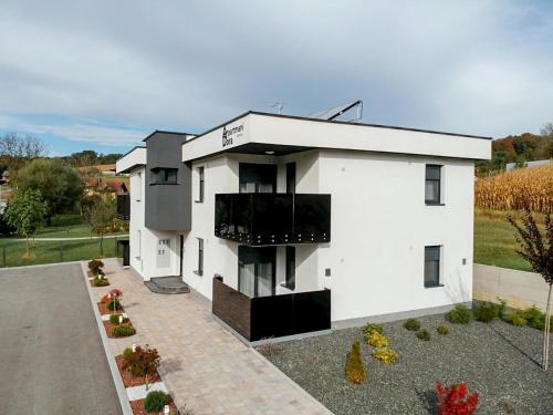 a white house with a driveway at Apartments Dora Sveti Martin na Muri in Sveti Martin na Muri
