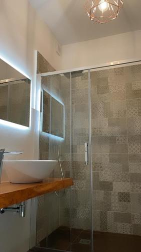 a bathroom with a sink and a glass shower at Relais Petruzzelli in Bari