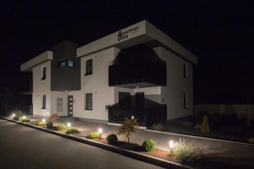 a large white building at night with lights at Apartments Dora Sveti Martin na Muri in Sveti Martin na Muri
