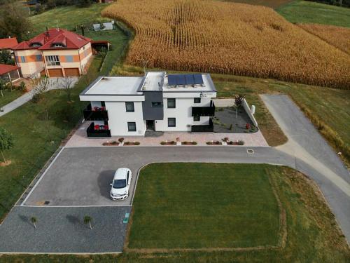 an aerial view of a house with a car in the driveway at Apartments Dora Sveti Martin na Muri in Sveti Martin na Muri