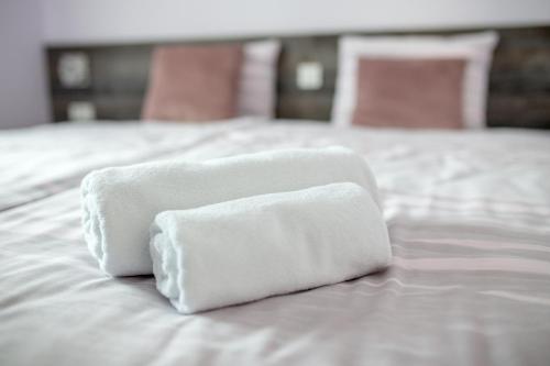 two towels sitting on top of a white bed at Apartments Dora Sveti Martin na Muri in Sveti Martin na Muri