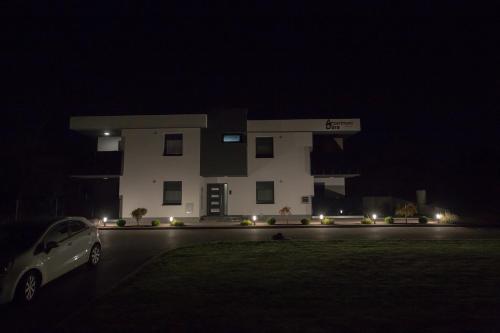 a car parked in front of a building at night at Apartments Dora Sveti Martin na Muri in Sveti Martin na Muri
