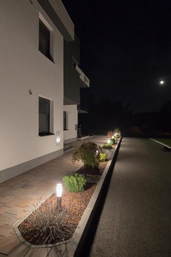 a building with lights on the side of a street at Apartments Dora Sveti Martin na Muri in Sveti Martin na Muri
