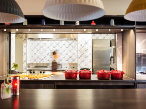 a kitchen with four red bowls on a counter at ibis Amsterdam Centre Stopera in Amsterdam
