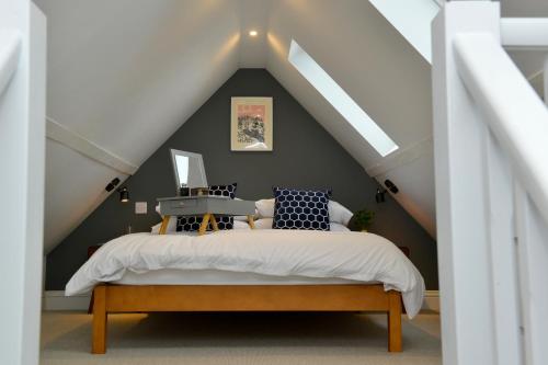 a bedroom with a bed in a attic at Nest House Super cosy one bedroom detached lodge center Huntingdon in Huntingdon