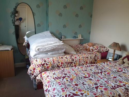 a bedroom with two beds with blankets and a stuffed animal at Eltham-Lee in Eltham