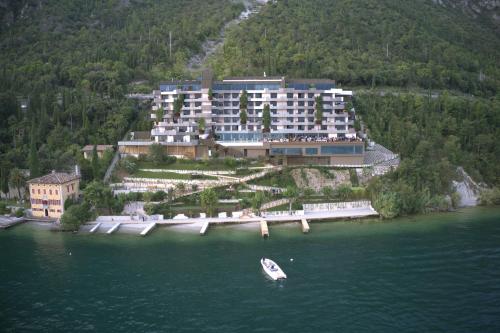 a large building on an island in the water at EALA My Lakeside Dream - Adults Friendly in Limone sul Garda