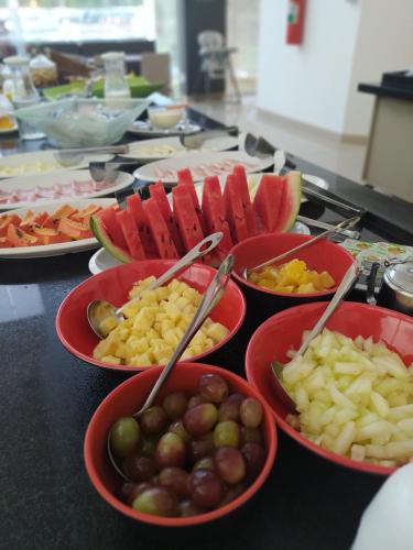a table topped with bowls of different types of food at ibis Presidente Prudente Manoel Goulart in Presidente Prudente