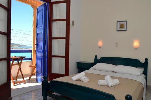 a bedroom with a bed with towels on it at To Petrino in Koufonisia
