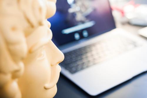 a toy head next to a laptop computer at Miceli Exclusive Suite in Palermo