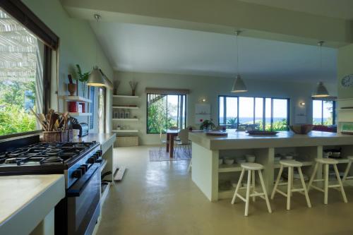 a kitchen with a large island with a stove top oven at Kangela 9 in Ponta Malongane