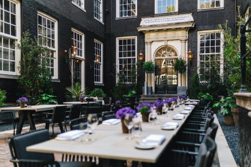 a row of tables in front of a building at The Dylan Amsterdam - The Leading Hotels of the World in Amsterdam