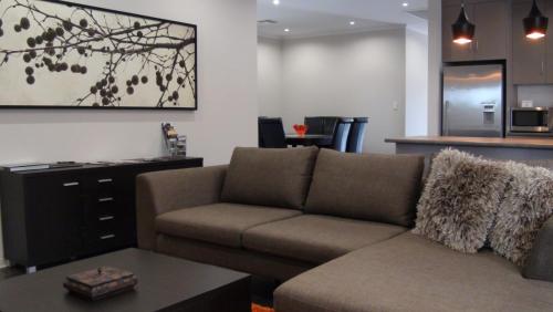 a living room with a couch and a table at Casavino Luxury Villa in McLaren Vale