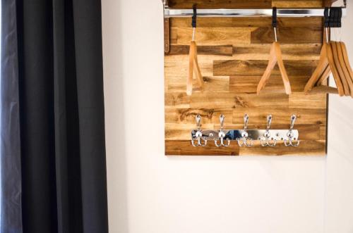 a room with a wooden wall with hooks on it at Hôtel De La Perdrix Rouge in Paris