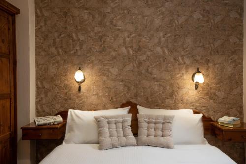 a bedroom with a white bed with two pillows at Villa Georgia in Kalyves