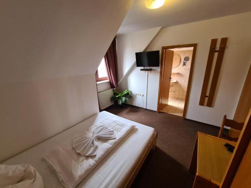 a bedroom with a bed with a bow on it at Hotel Ceteno in Wunstorf