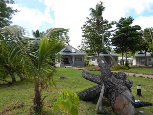a statue of a palm tree in front of a house at Cote d'Or Footprints in Baie Sainte Anne