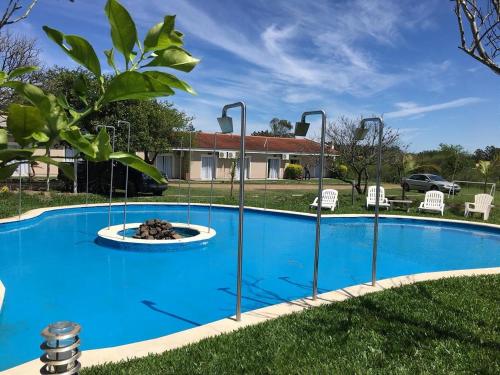 a pool with a fire pit in the grass at Club Valle Termal Resort in Federación
