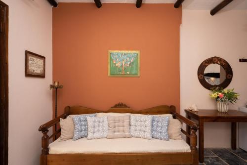 a room with a bed with a mirror and a painting at Villa Georgia in Kalyves