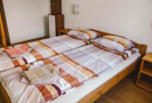 a bed with a quilt and pillows on it at Haanja Guest Apartment with Sauna in Haanja