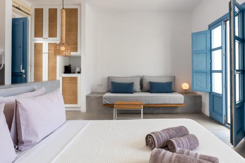 a living room with a couch and a table at Ihthioessa Boutique Hotel in Astypalaia Town