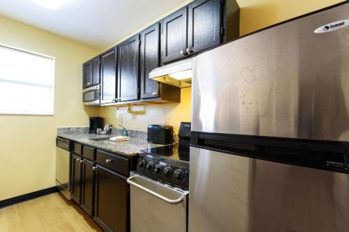 a kitchen with stainless steel appliances and black cabinets at Extended Stay America Suites - Chicago - Elgin - West Dundee in West Dundee