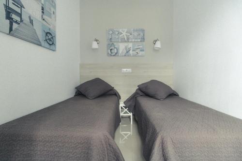 two beds in a room with two beds sidx sidx sidx at Puerto Mogan Apartment in Puerto de Mogán