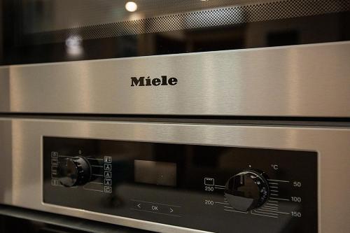 a microwave oven with the word midele on it at Anemone Villa with Outdoor Hot Tub, Sani Luxury Villas collection in Sani Beach