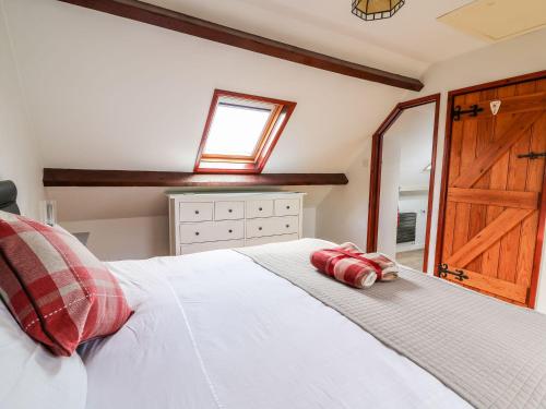 a bedroom with a white bed with a wooden door at Caecrwn in Brecon