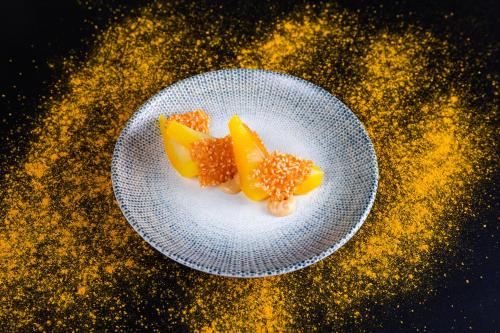 two slices of oranges on a plate on a table at Vox Hotel in Jönköping