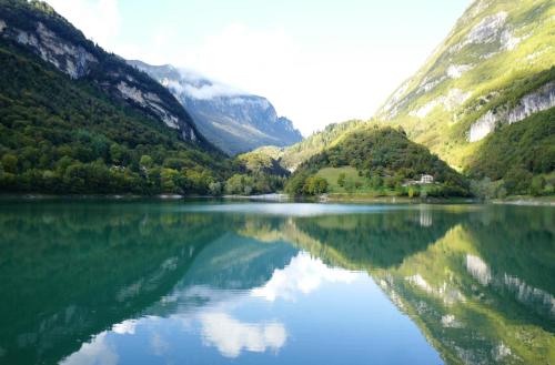 a lake in the middle of a valley with mountains at Club Hotel Tenno in Tenno