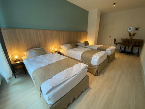 a hotel room with two beds and a table at Aparthotel Charlotten in Hannover