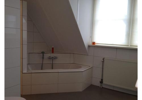 a bathroom with a bath tub in a room at Vakantiewoning Yerseke in Yerseke