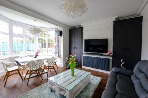 a living room with a couch and a table at Robertsbrook Guest House in Swanage