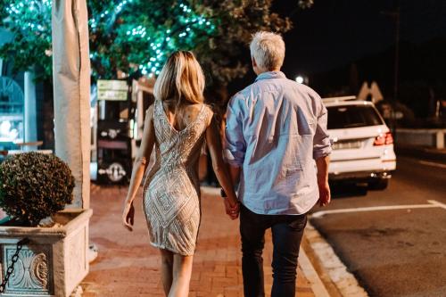 a man and a woman walking down a sidewalk at night at Last Word Franschhoek in Franschhoek