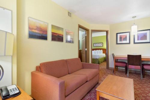 a living room with a couch and a table at Extended Stay America Suites - Norfolk - Virginia Beach in Virginia Beach