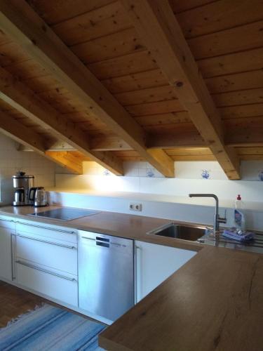 a kitchen with white cabinets and a sink at Ferienwohnung Alpensonne in Oberstdorf