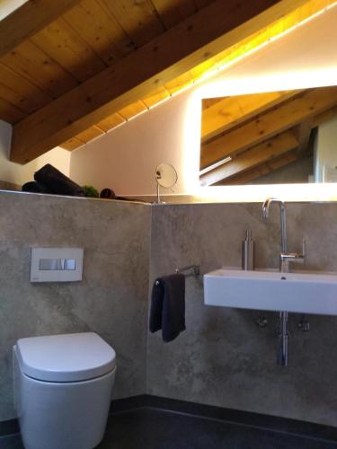 a bathroom with a white toilet and a sink at Ferienwohnung Alpensonne in Oberstdorf