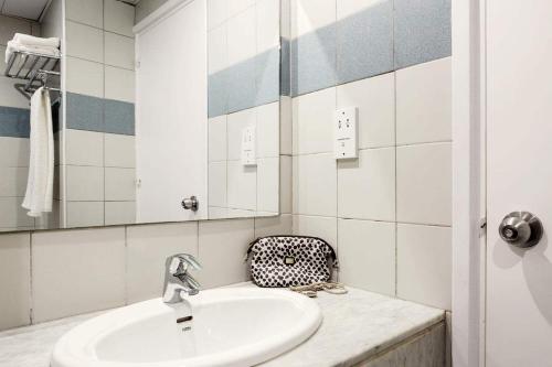 a bathroom with a sink and a mirror at Lantiana Gardens ApartHotel in Protaras